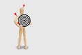 Many red darts missed hit target on dartboard isolated on gray background.