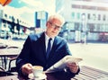 Senior businessman with newspaper drinking coffee Royalty Free Stock Photo