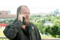 Business mature male tourist with a beard talking on the phone Royalty Free Stock Photo