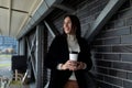 Business mature woman with a cup of coffee in her hands during a lunch break looks into the distance with a smile Royalty Free Stock Photo