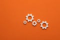 Business mechanism concept, flat graphic resource for design - Gears on orange color background