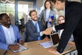 Business meeting associates shaking hands in office. Royalty Free Stock Photo