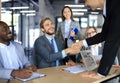 Business meeting associates shaking hands in office. Royalty Free Stock Photo