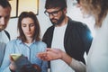 Business meeting concept.Coworkers working with mobile devices at modern office.Blurred background.Horizontal. Royalty Free Stock Photo