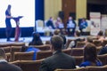 Business Meeting and Conferences Ideas. Group of People Attending Conference and Listening to the Host Speaker On Stage. Back Vie Royalty Free Stock Photo