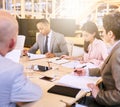 Business meeting between four professional entrepreneurial executives indoors Royalty Free Stock Photo