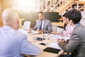 Business meeting between four professional entrepreneurial executives indoors Royalty Free Stock Photo