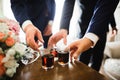 Business meeting. Men hold glasses of whiskey. Men`s Party. Hand with a drink of alcohol