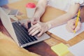 Business meeting in modern office, close-up of woman hands on keyboard laptop on wooden table, man hand writing by pencil. Royalty Free Stock Photo