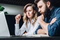 Business meeting. Teamwork. Businesswoman and businessman sitting at table in front of laptop and working. Royalty Free Stock Photo