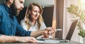 Business meeting. Teamwork. Businesswoman and businessman sitting at table in front of laptop and working. E-learning. Royalty Free Stock Photo