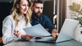 Business meeting. Teamwork. Businesswoman and businessman sitting at table in front of laptop, working. Online marketing Royalty Free Stock Photo