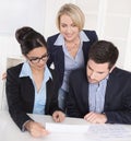 Business meeting. Three people sitting at the table in an office Royalty Free Stock Photo