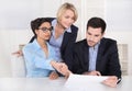 Business meeting. Three people sitting at the table in an office Royalty Free Stock Photo