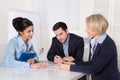 Business meeting. Three people sitting at the table in an office Royalty Free Stock Photo