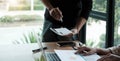 Business meeting time. Photo young account managers crew working with new startup project. Notebook on wood table. Idea Royalty Free Stock Photo