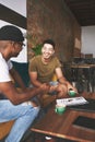 A business meeting wouldnt be the same without good coffee. two men laughing while sitting together in a coffee shop. Royalty Free Stock Photo