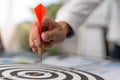 Business men aiming to be successful Business ambitions. Man holds a red darts stabbed to the middle target ,Business target or go