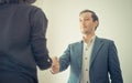 Business man gladly smile shaking hand with partner