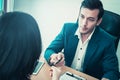 Business man handing pen to a woman for contract signing Royalty Free Stock Photo