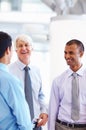 Business men in happy discussion. Portrait of three business men in happy discussion at office. Royalty Free Stock Photo