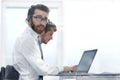 Business man in headphones sitting at his Desk Royalty Free Stock Photo