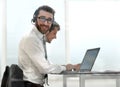 Business man in headphones sitting at his Desk Royalty Free Stock Photo