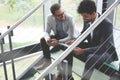 Business men sitting on the stairs. Business people having conve