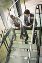 Business men sitting on the stairs. Business people having conve