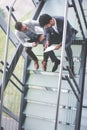 Business men sitting on the stairs. Business people having conve