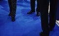 Business Men in Suits Standing on a Blue Carpet