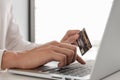 Business men use credit cards and laptops for online shopping and making payments the internet