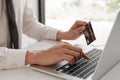 Business men use credit cards and laptops for online shopping and making payments the interne.