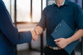 Business men and women shake hands confidently professional investor working with new startup project at an office meeting