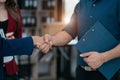 Business men and women shake hands confidently professional investor working with new startup project at an office meeting