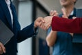 Business men and women shake hands confidently professional investor working with new startup project at an office meeting