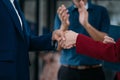 Business men and women shake hands confidently professional investor working with new startup project at an office meeting