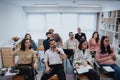 Business men and women of various ages engaging in a business workshop in a contemporary office setting, exemplifying Royalty Free Stock Photo