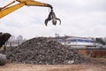 In the business of metal. Cropped shot of an excavator sorting through a pile of scrap metal. Royalty Free Stock Photo