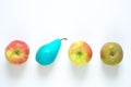 Business metaphor,solution,innovation,idea,consulting, thinking different, row of apples with one pear blue colored, flat lay,