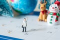 business miniature figures people on 31 day calendar and christmas ornamental background