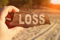 A man holds a sign in his hands - LOSS