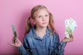 Business and money concept - happy little girl with euro cash money over pink background Royalty Free Stock Photo