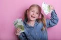 Business and money concept - happy little girl with euro cash money over pink background Royalty Free Stock Photo