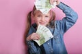 Business and money concept - happy little girl with euro cash money over pink background Royalty Free Stock Photo