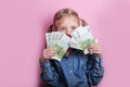 Business and money concept - happy little girl with euro cash money over pink background Royalty Free Stock Photo