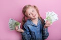 Business and money concept - happy little girl with euro cash money over pink background Royalty Free Stock Photo