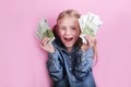 Business and money concept - happy little girl with euro cash money over pink background Royalty Free Stock Photo