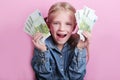 Business and money concept - happy little girl with euro cash money over pink background Royalty Free Stock Photo