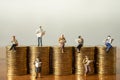 Business, Money Investment and Planning Concept.  Group of Businessman miniature figure people figure reading book and newspaper Royalty Free Stock Photo